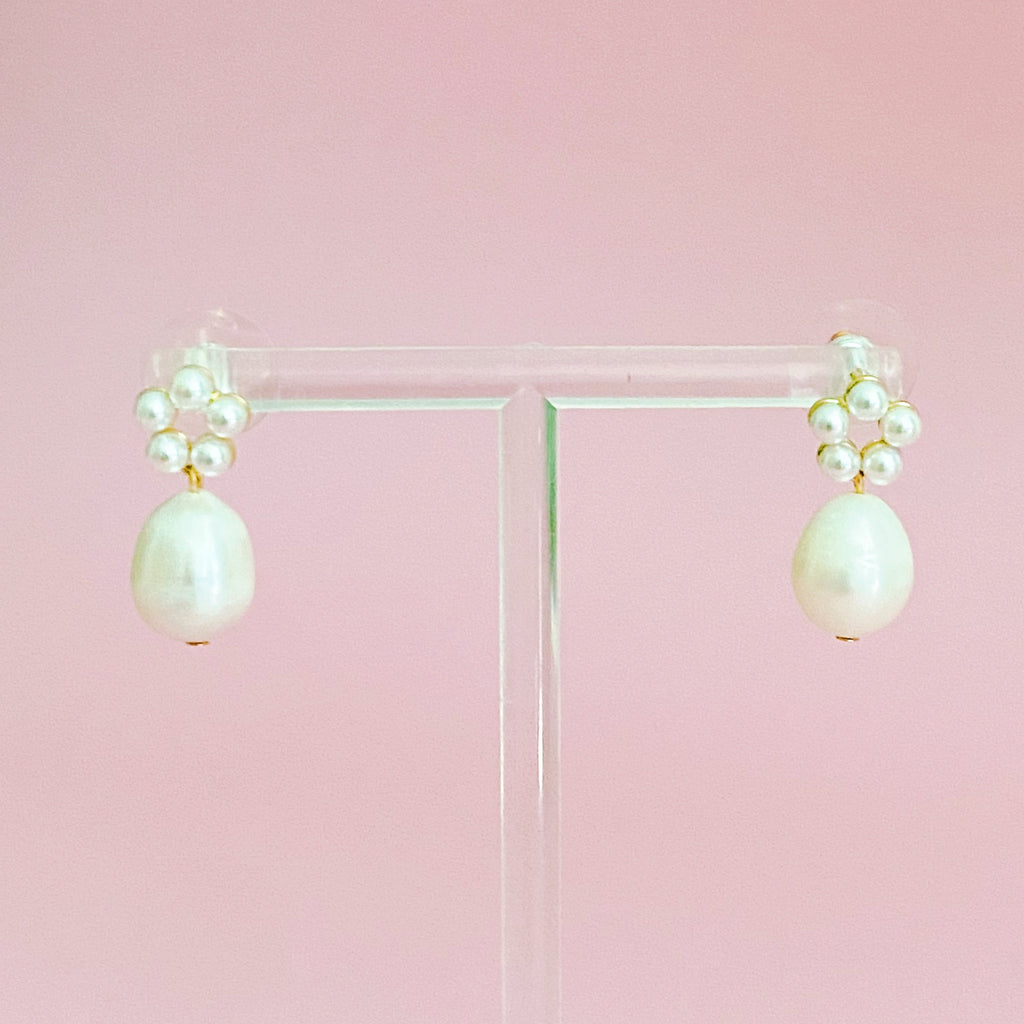 Pearl drop earrings worn